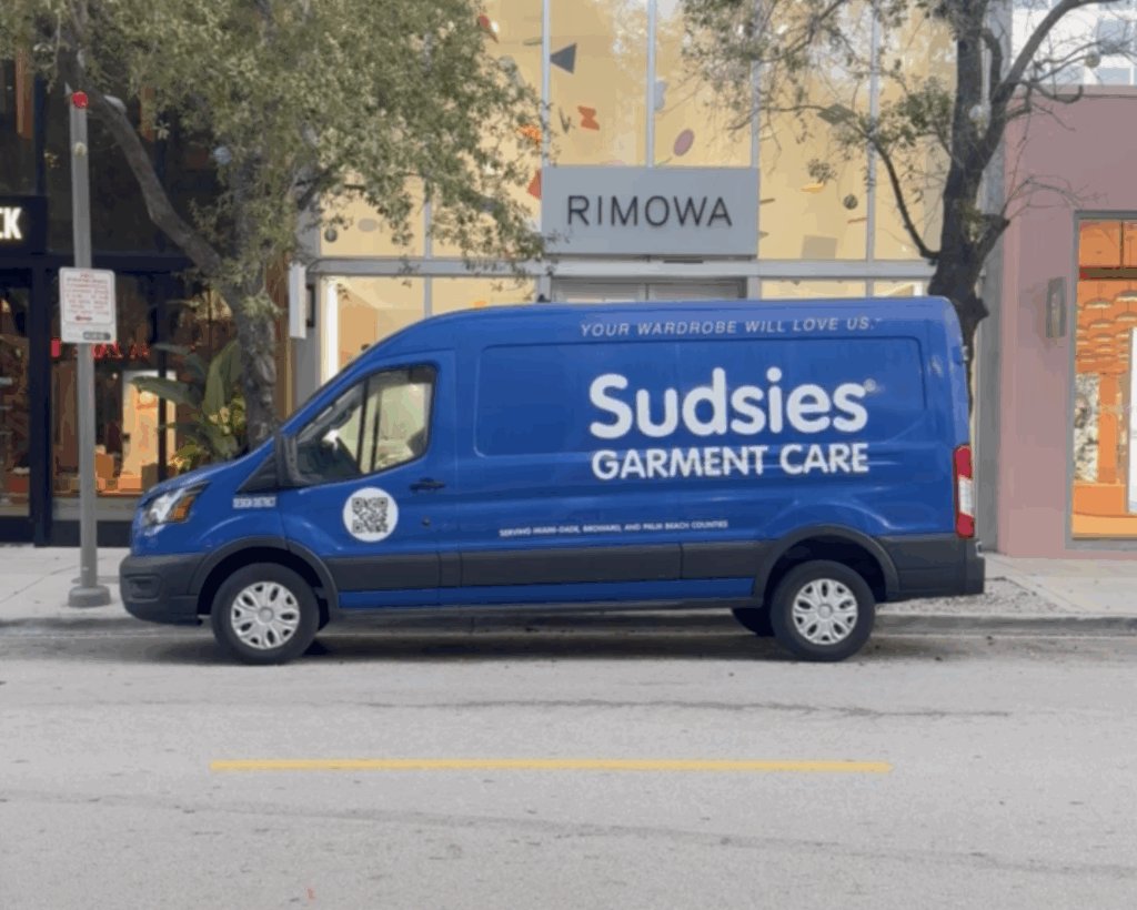 Sudsies Van at Rimowa Miami | Luxury Garment Care Pickup & Delivery | Sudsies Sudsies garment care valet van parked outside Rimowa boutique in Miami’s Design District